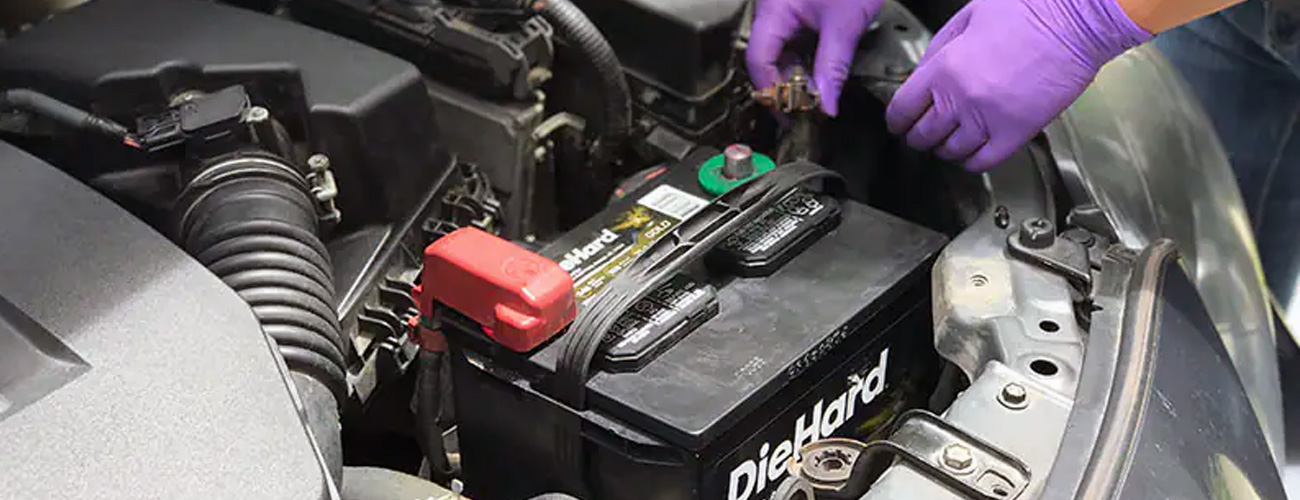 Mobile car battery fitter in London testing a car battery